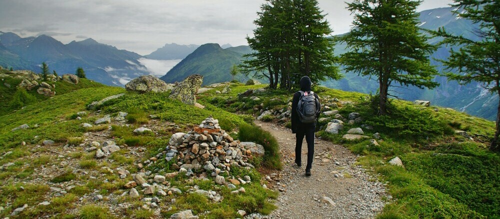 person walking on a mountain path